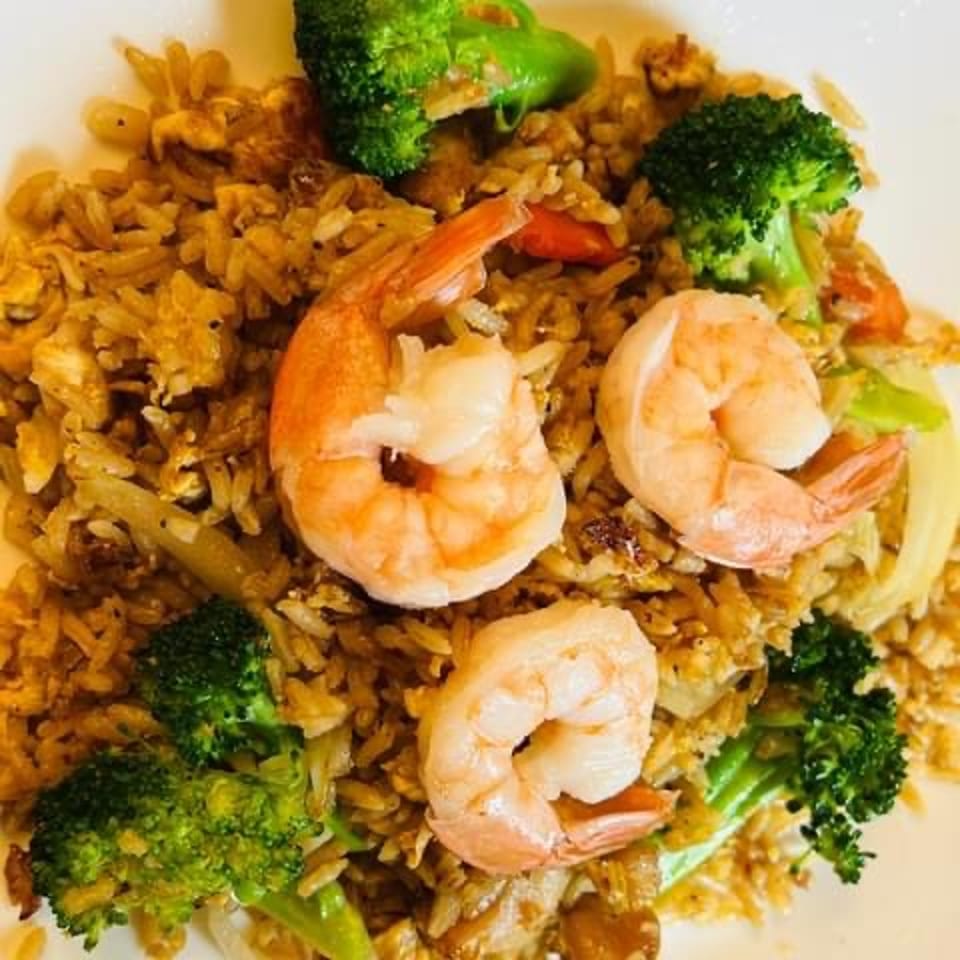 Shrimp fried rice with broccoli, scallions, and sliced cucumber.
