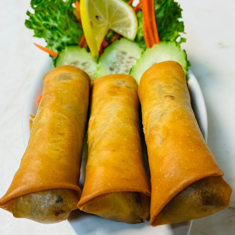 Keziah's crispy rolls served with fresh lettuce, cucumber, carrot, and lemon.